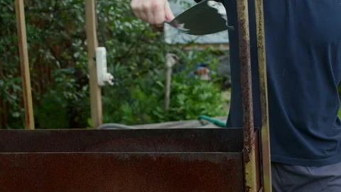 Close up empty rusty metal grill box outdoors with garden background Stock Footage 323250176