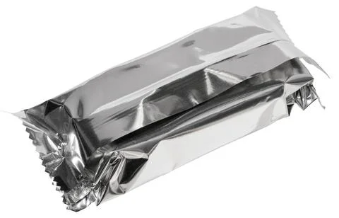 Close up of empty silver foil packaging for candy bar or snack, crumpled an.. Stock Photos