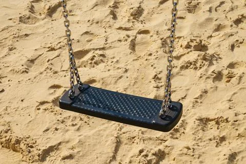 Close-up of empty swing on children playground. Stockfoto's