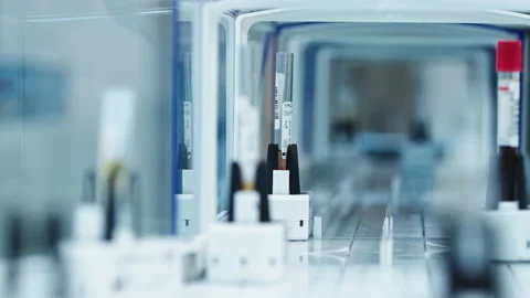 Close-up of empty test tubes moving around inside an automated lab glazed line Stock Footage 233072880