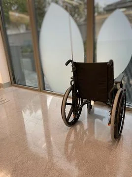 Close-up Empty wheelchair in front of a window of a Hospital outpatient clini Stock Photos