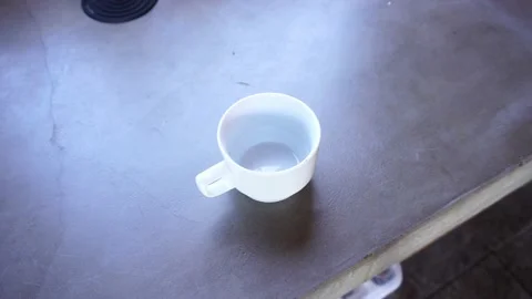 Close up of empty white cup on concrete kitchen table at daytime in 4k Stock Footage 199509394