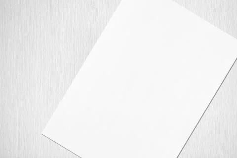 Close up of empty white rectangle poster mockup lying diagonally on grey conc Foto stock