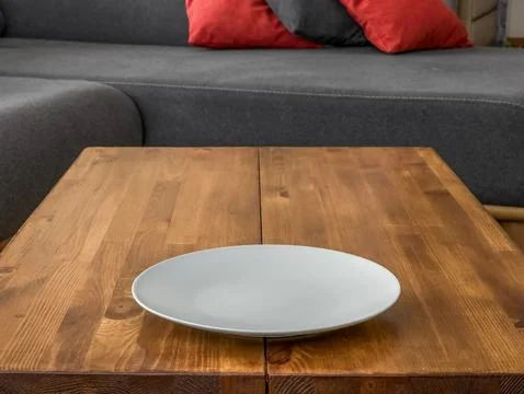 Close up of empty white round plate on wooden table Stock Photos