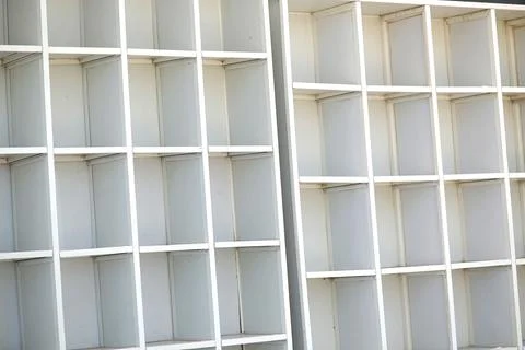 Close-up of empty white shelving units in industrial setting Stock Photos