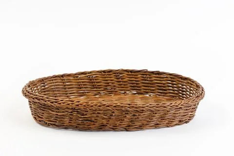 Close up of an empty wicker basket on a white background. Stock Photos