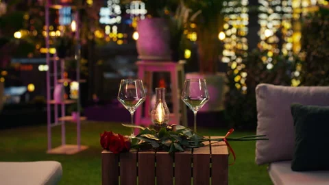 Close up of empty wine glasses, lamp and roses on restaurant table Stock Footage 347080757