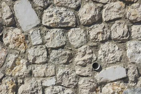 Close-up of empty,stone wall with drain pipe,backgrounds Stock Photos