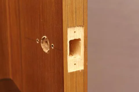 Close-up end hole for door latch inserting. Markup for doorknob installing. Stock Photos