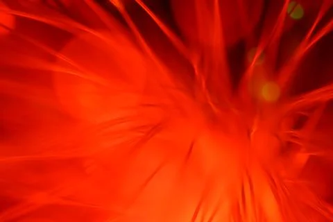 Close up on the ends of a selection of illuminated red fiber optic light stra Stock Photos