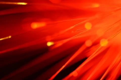 Close up on the ends of a selection of illuminated red fiber optic light stra Stock Photos
