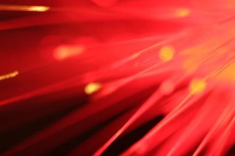 Close up on the ends of a selection of illuminated red fiber optic light stra Stock Photos