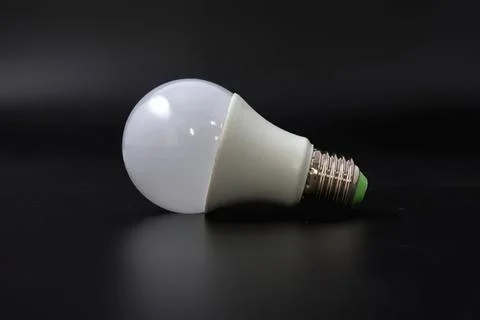 Close-up of energy saving led light bulb on black background Stock Photos