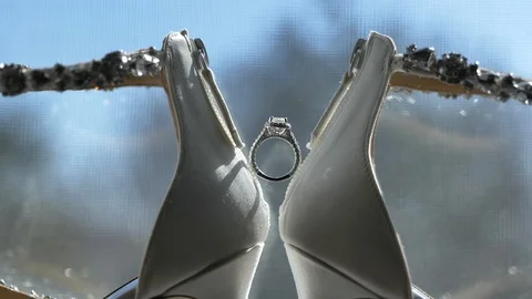 Close up engagement ring sitting in between shoe heels window Video stock 125431934