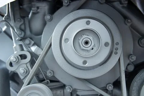 Close-up of an engine with belts and pulleys, demonstrating the mechanical po Stock Photos