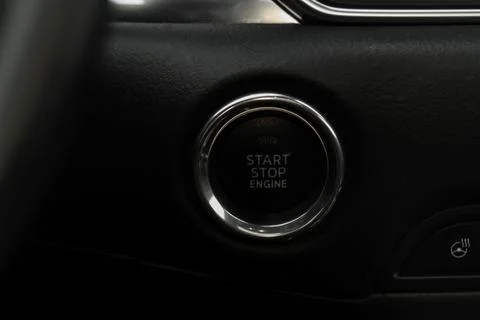 Close up engine car start stop button. Modern car black interior details. Stock Photos