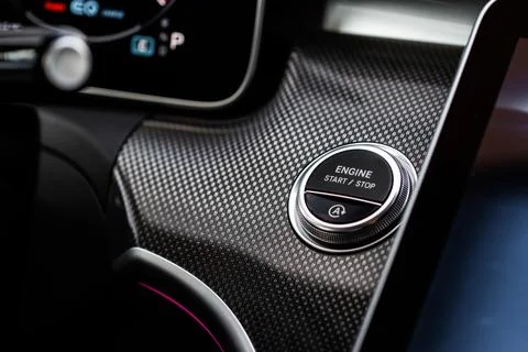 Close up engine car start stop button. Modern car black interior details. Stock Photos