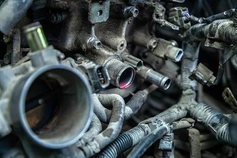 Close-up of engine failure: pink antifreeze flows from the engine pipes of an Stock Photos