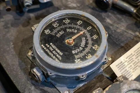 A close-up of an engine features a prominent circular gauge with numerical va Stock Photos