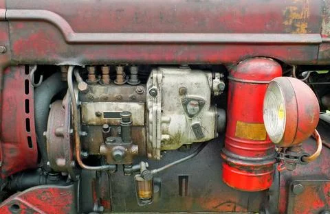  a close up of the engine of an old vintage tractor with red rusty bodywor... 写真素材