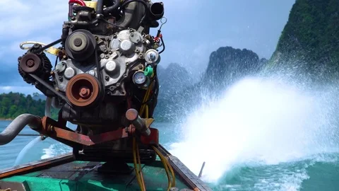 A close-up of an engine on a thai longtail boat and a spray from its propeller. Stock Footage 82679330