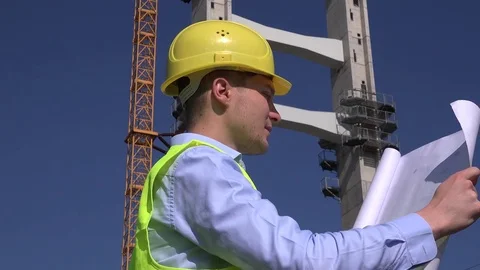 Close up engineer architect at work reading blueprint smile cheerful to camera Stock Footage