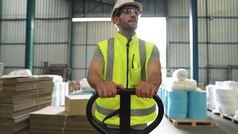Close-up, engineer carrying a cart in a warehouse Stock Footage 139820338