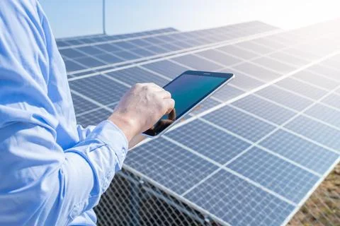Close-up of a engineer checking solar panel setup. Using smart app in tablet Stock Photos