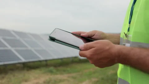 Close up of engineer is checking with tablet PC an operation of field of Stock Footage 156809980