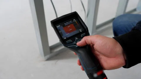 Close up. An engineer checks the heated floors with a thermal imager. 스톡 동영상 129070197