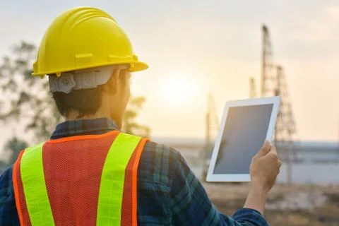 Close up Engineer Construction holding tablet checking work estate technology Stock Photos
