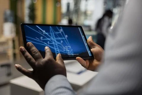Close up of engineer designing eco power line towers on tablet 스톡 사진
