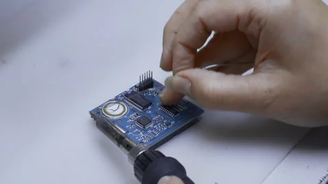 Close up of engineer does computer motherboard soldering. Creative. Painstaking Stock Footage 260860209