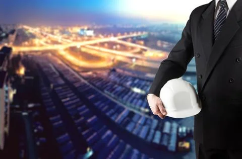 Close up of engineer hand holding white safety helmet for worker Stock Photos