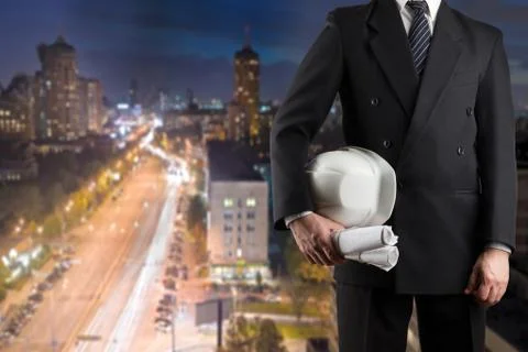 Close up of engineer hand holding white safety helmet for worker Stock Photos