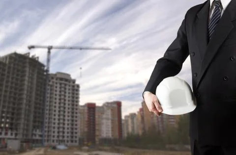 Close up of engineer hand holding white safety helmet for worker 库存照片