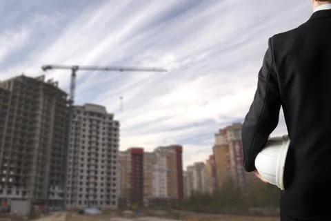 Close up of engineer hand holding white safety helmet for worker Stock Photos