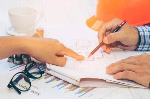 Close up of engineer hands discussing a building construction project at work Stock Photos