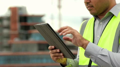 Close up engineer handsome man or architect use tablet with white safety helmet  库存影片 164835953