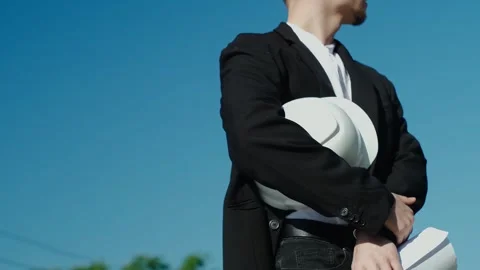 Close-up of an engineer holding a construction helmet against the backdrop of a Stock Footage 249263014