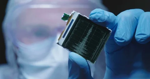 Close up of  an engineer is holding a microchip with futuristic hologram. Stock Footage 115368613