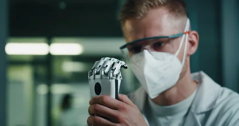 Close Up of Engineer in a Lab Testing a Prosthetic Hand Stock Footage 229692137