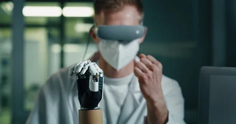Close Up of Engineer in a Lab Testing a Prosthetic Hand Stock Footage 229692500