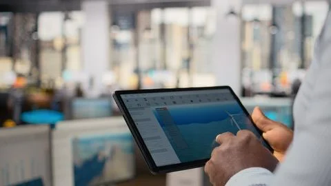 Close up of engineer in office using tablet to work on wind turbine CAD design 写真素材