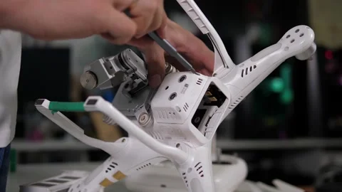 Close-up of an engineer repairing a quadcopter in the studio. Stock Footage 288333651
