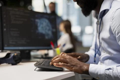 Close up of engineer typing on PC keyboard, coding with AI 写真素材