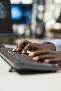 Close up of engineer typing on PC keyboard in office, automating repetitive task 写真素材
