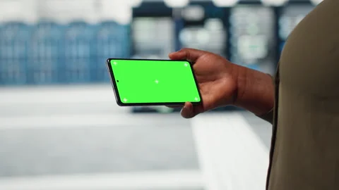 Close up of engineer using app on mockup phone to do server hub checkup Stock Footage 317201057