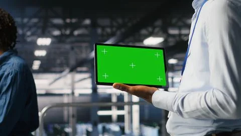 Close up of engineer using green screen mockup tablet in data center Stock Photos