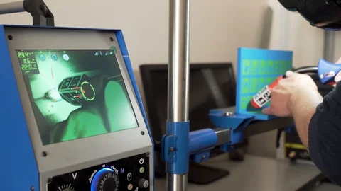Close up of an engineer using modern welding equipment and a computer for Stock Footage 127645120